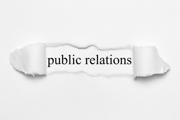 public relations on white torn paper
