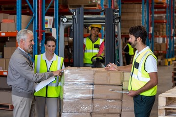 Warehouse manager and workers preparing a shipment