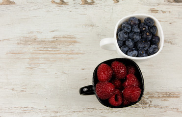 Fruit blueberries and raspberries in cups