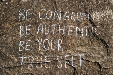 Be congruent be authentic be your true self. Creative motivation concept is written on a stone.