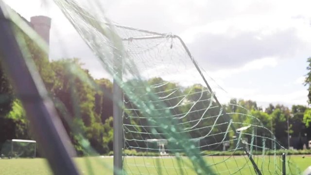 ball flying into football goal net on field