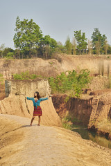 hippie girl dancing on cliff