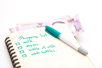 Preparing the shopping list and banknote before going to buy the