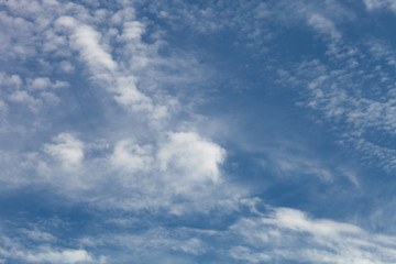 Naklejka na ściany i meble White clouds on a blue sky. Selective focus