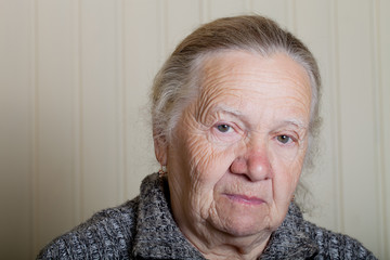 Portrait of an elderly woman on a light background