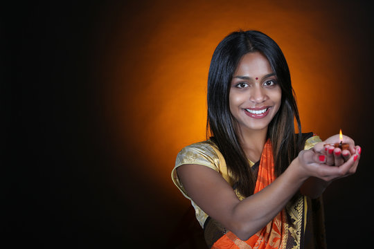 indian woman holding oil lamp for diwali festival