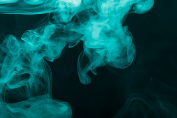 Cloud of smoke on black background. Selective focus. Toned