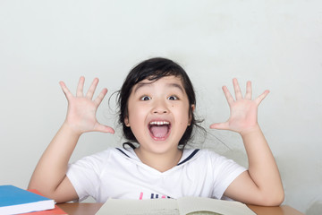 Happy Asian child hands up
