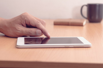 Smartphone or tablet computer male hand touching screen, vintage