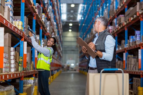 Warehouse manager and female worker interacting while working