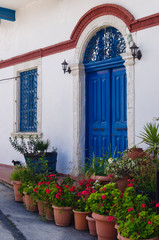 Beautiful blue entrance door to the house in a Mediterranean sty