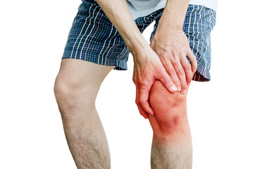 Acute pain in a man knee. male holding hand to spot of knee-ache.Isolation on a white background.