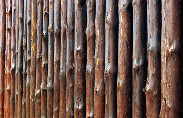 Wooden fence made of oak tree trunks. Focus is in the middle