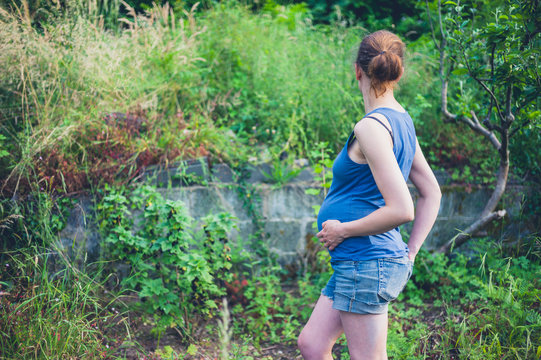 Pregnant woman in garden