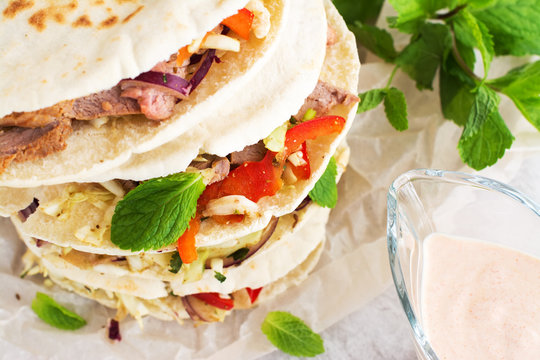 Meat pita bread with yogurt sauce and mint leaves