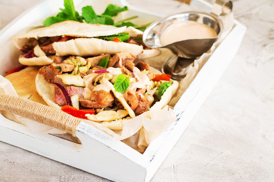 Greek pita bread with meat and salad