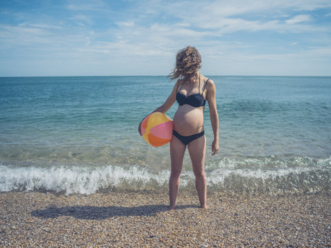 Pregnant woman with beach ball