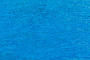 Blue swimming pool water surface texture.