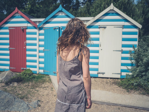 Young woman by beach huts