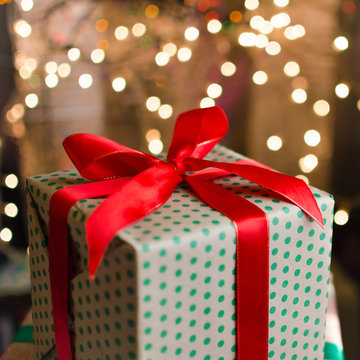 christmas gifts indoor on defocused lights background space for text