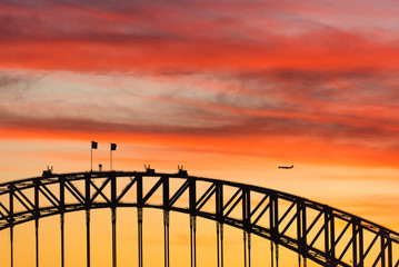 Fototapeta na wymiar Colorful dramatic sky with silhouette of Sydney Harbour Bridge