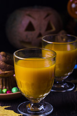 Halloween cocktail, pumpkin orange drink with spices