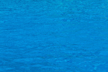 Blue swimming pool water surface texture.