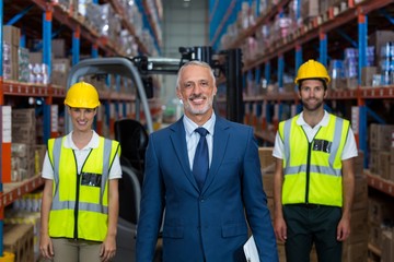 Portrait of warehouse manager and co-workers 