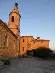 Fototapeta na wymiar Church in the Provencal village of Crillon-le-Brave caught by the last rays of the setting sun