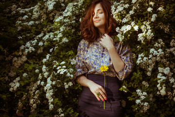 incredibly beautiful woman standing near green bush