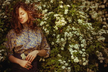 incredibly beautiful woman standing near green bush