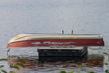 Boat upside down on a floating platform.