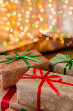 christmas gift boxes indoor on defocused lights background space for text