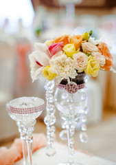 High vase with crystal chains stands on the table