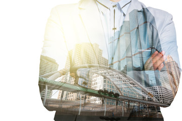 Double Exposure of Businessman and Business building City at Sun