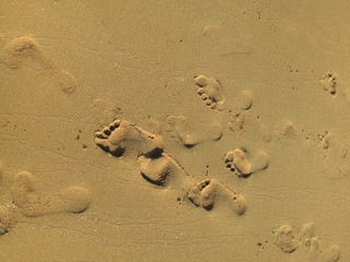 Fototapeta na wymiar Sea sand with footprints