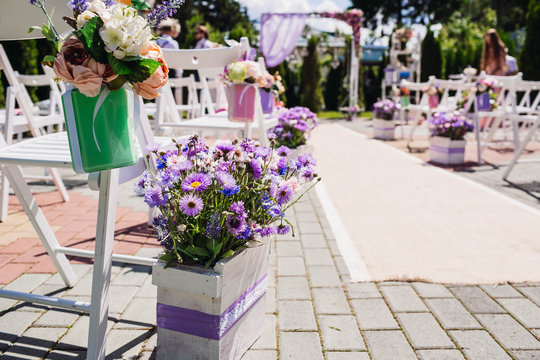 beautiful white arch and chairs with flowers for wedding ceremon