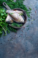 Delicious fresh fish on dark vintage background.