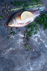 Delicious fresh fish on dark vintage background.