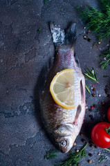 Delicious fresh fish on dark vintage background.
