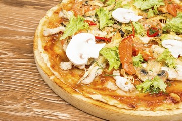 Delicious fresh pizza served on wooden table.