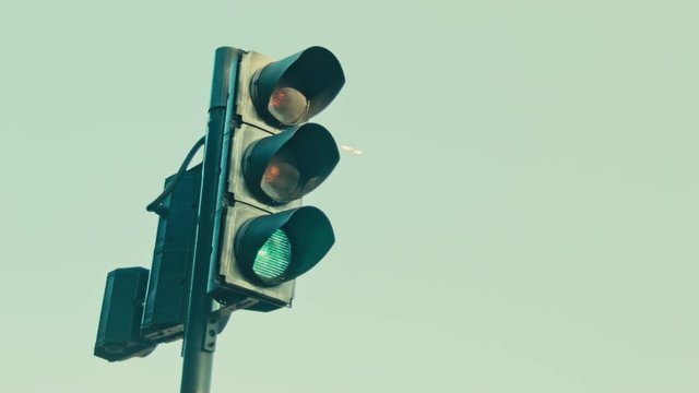 Traffic light, plane in the background.
Bus passing.