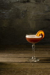 Wine in a glass with a citrus piece