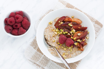 oatmeal with baked fruit for breakfast, top view