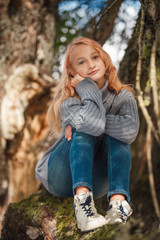 The little girl in the autumn forest