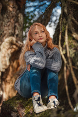 The little girl in the autumn forest