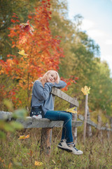 The little girl in the autumn forest