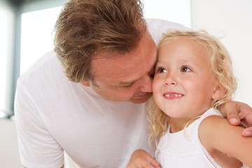 Loving father with his cute little daughter at home