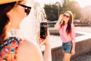 happy girls make picture together and having fun,laughing and make funny faces on camera