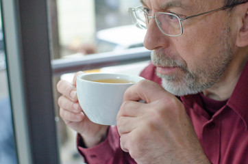 aged man with a cup of tea